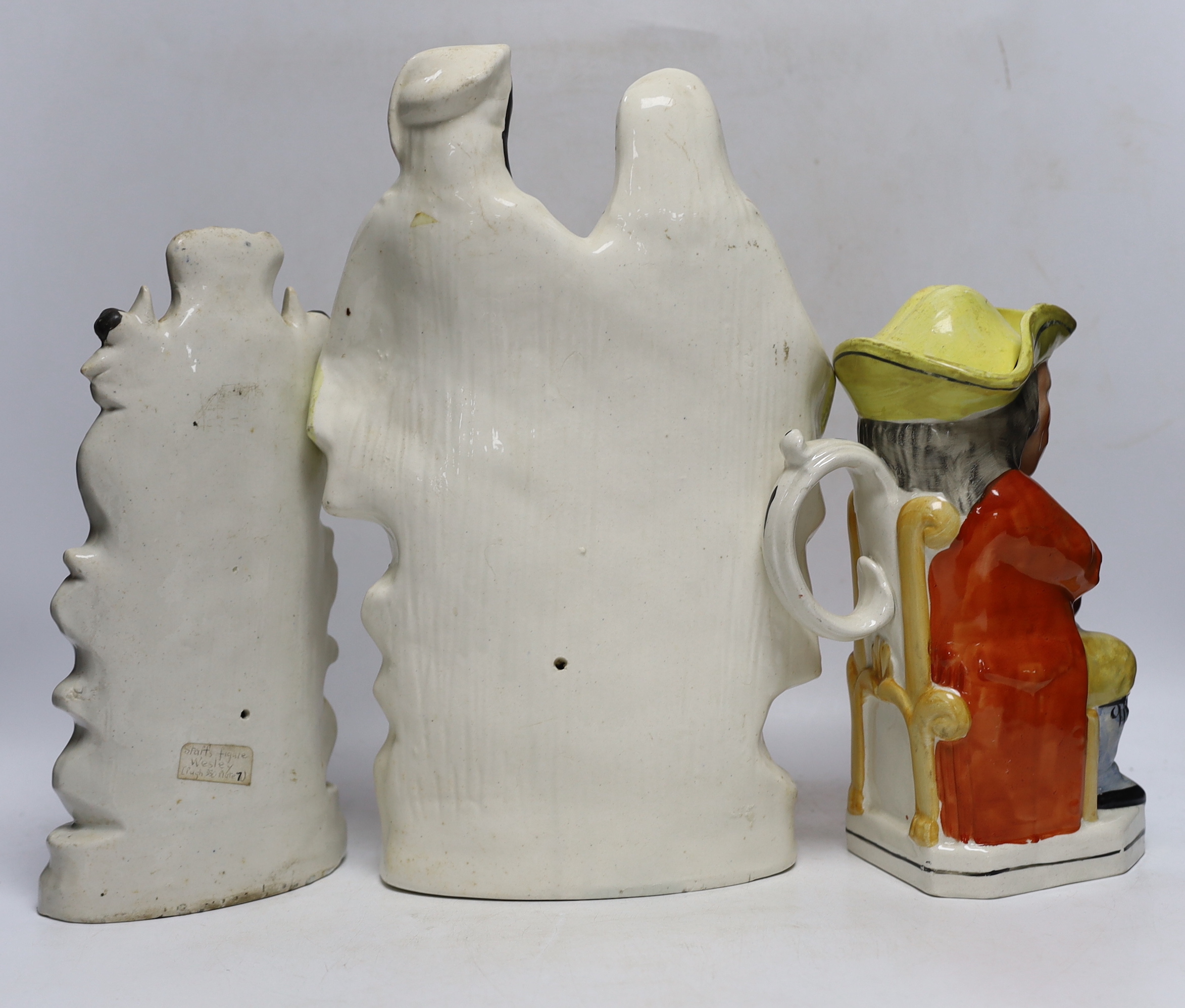 Seven 19th century Staffordshire figure groups including Orange Sellers and Wesley, together with a Toby jug, 35cm high